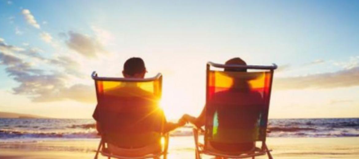 Retired couple sitting on deck chairs