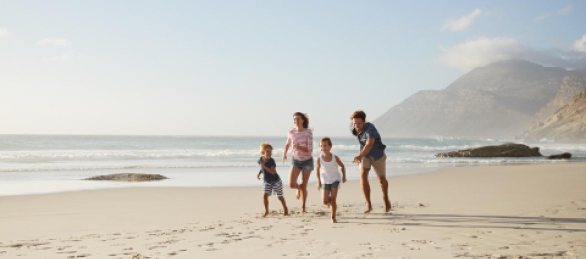 Family running on the beach