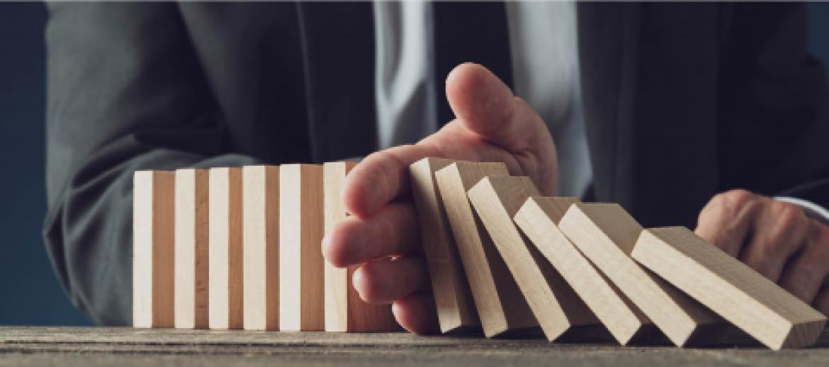 Businessman protecting business with hand