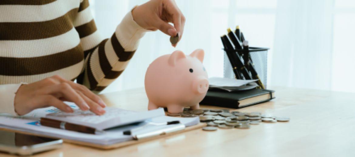 woman putting money in money bank