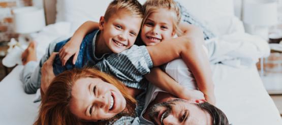 family playing on bed