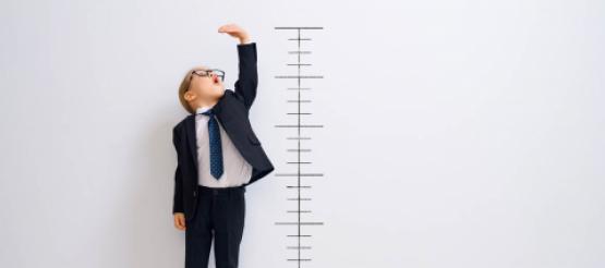 Boy standing next to measurement