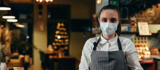 Waitress wearing mask in restaurant