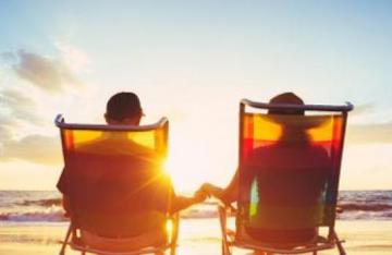 Retired couple sitting on deck chairs