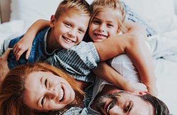 family playing on bed