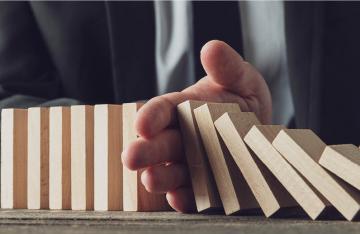 Businessman protecting business with hand