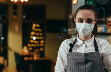 Waitress wearing mask in restaurant