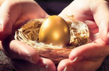 hands holding golden egg