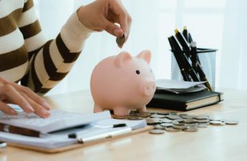 woman putting money in money bank