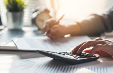 man playing with calculator