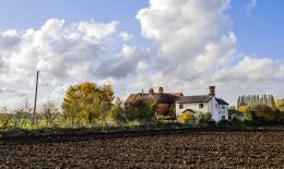 UK farmhouse surrounded by farmland