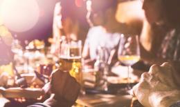 People eating around a restaurant table 