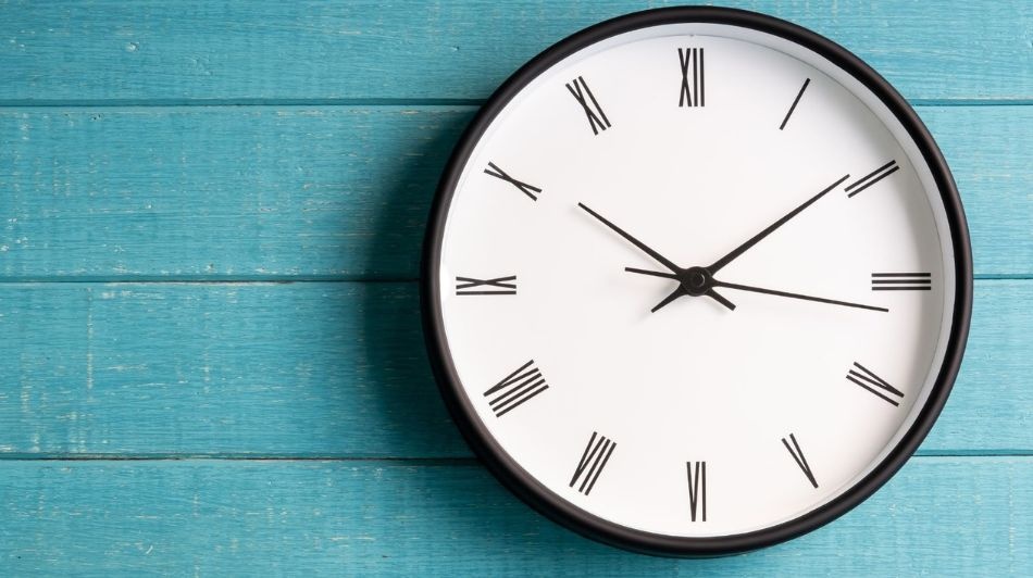 Wall clock with Roman numerals symbolising time pressure and filing before a deadline.