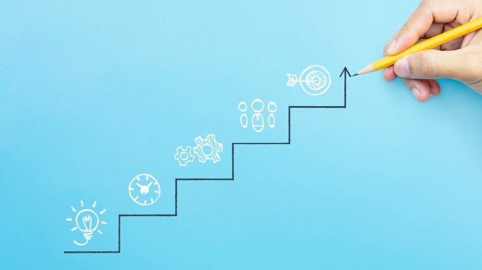 Hand sketching a rising staircase chart toward a target, symbolizing business growth and strategic planning.