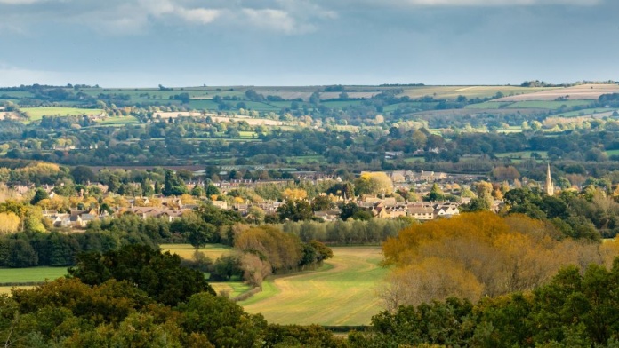 Rural market town nestled among farmland and rolling countryside, illustrating land use and property value.