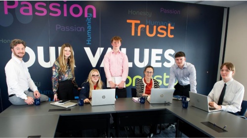 Tax Compliance Managers and apprentices at Armstrong Watson. Sitting at a desk with lap