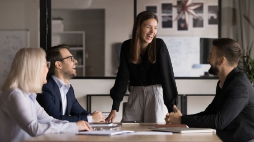 Colleagues collaborating in a modern office meeting room during a team discussion.