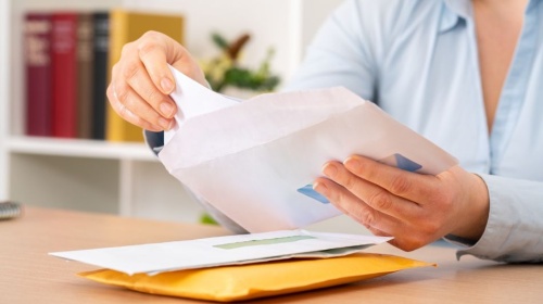 Person opening a letter