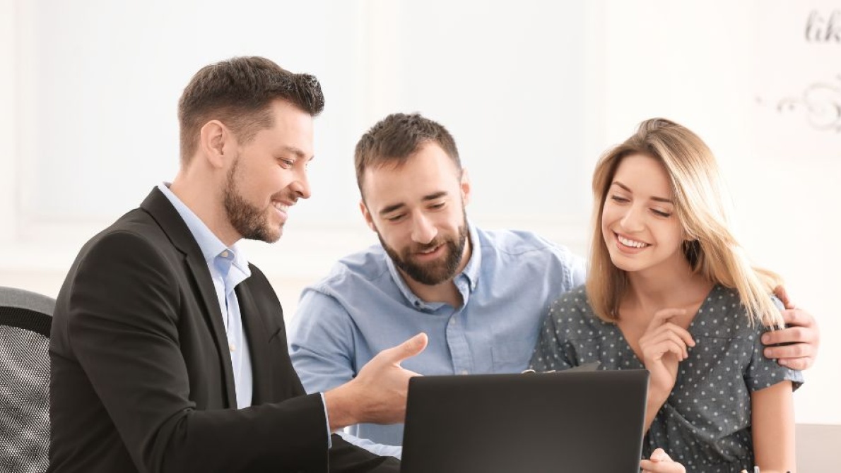 Adviser working with a couple to achieve financial goals 