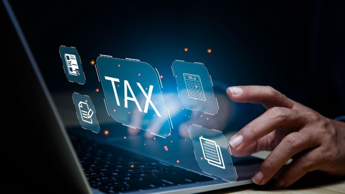 Digital tax with fingers typing on a laptop