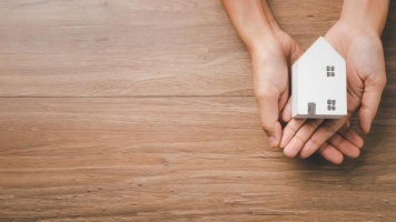 hand holding a small house