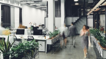 people walking through an office