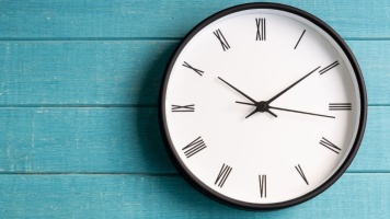 Wall clock with Roman numerals symbolising time pressure and filing before a deadline.