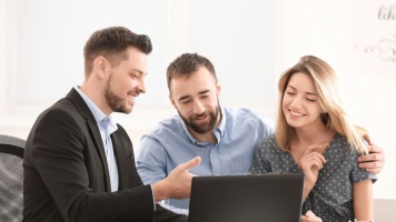 Adviser working with a couple to achieve financial goals 