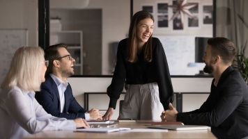Colleagues collaborating in a modern office meeting room during a team discussion.