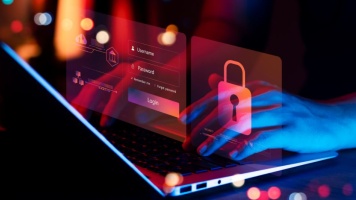 Cybersecurity concept showing hands typing on a laptop with digital login credentials and padlock security icons overlayed on screen.