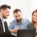 Adviser working with a couple to achieve financial goals 