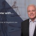 Interview banner with Frank Maher, Solicitor and Partner at Keystone Law, beside a Lady Justice statue.