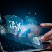 Digital tax with fingers typing on a laptop