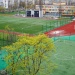 Modern school sports complex with football pitches, running track, and outdoor athletic facilities