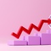 Red upward-trending arrow rising across stepped blocks toward a target, symbolizing business growth, financial performance, and goal achievement.