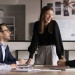Colleagues collaborating in a modern office meeting room during a team discussion.